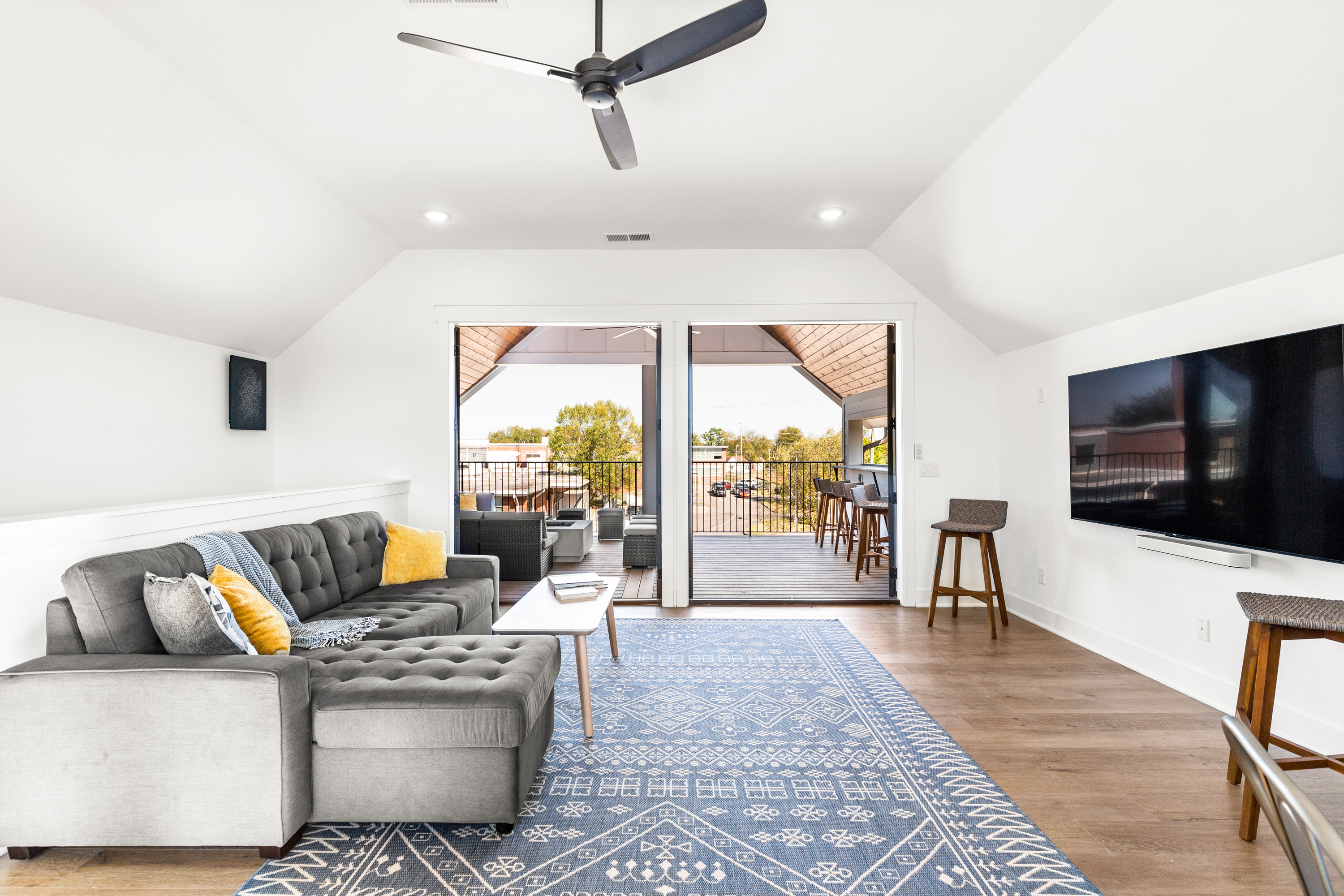 Modern lounge with large sectional sofa and balcony access